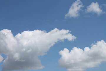 Obraz premium Clouds in a blue sky ,white fluffy clouds on a back ground of blue sky on a summers day Knottingley West Yorkshire In UK