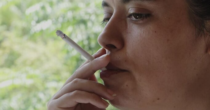 Smoking a cigarette, unhealthy lifestyle