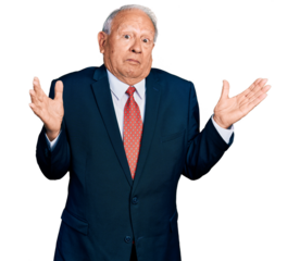 Senior man with grey hair wearing business suit and tie clueless and confused with open arms, no idea and doubtful face.