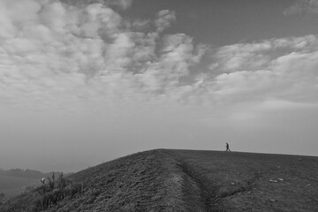 Fototapeta premium man walking up a hill