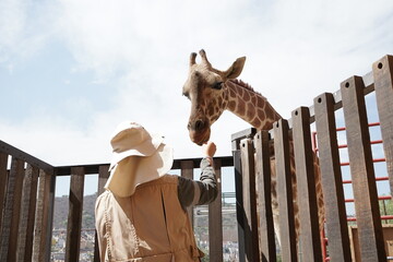 zoo keeper with a giraffe