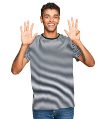 Young handsome african american man wearing casual clothes showing and pointing up with fingers number nine while smiling confident and happy.