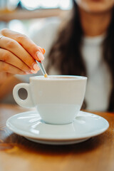 One young caucasian woman is drinking coffee in cafe or restaurant and enjoying her time	