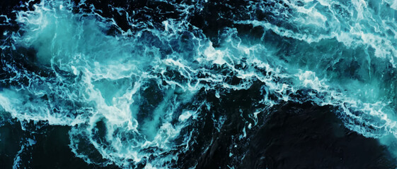 aerial drone image top looking down of surf waves rolling over a reef with white water break