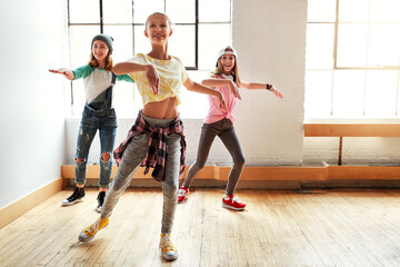 Dance, girl group and children with routine, studio and rhythm for creative art performance or rehearsal. Smile, friends and happy kids in cool hip hop crew for practice, motion or learning in class