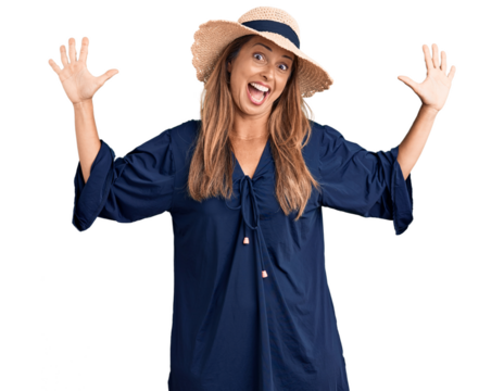 Middle age hispanic woman wearing summer hat showing and pointing up with fingers number ten while smiling confident and happy.