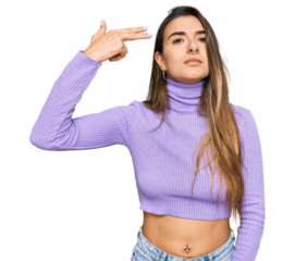 Young hispanic woman wearing casual clothes shooting and killing oneself pointing hand and fingers to head like gun, suicide gesture.