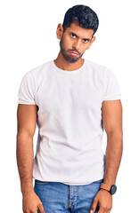 Obraz premium Young latin man wearing casual clothes depressed and worry for distress, crying angry and afraid. sad expression.