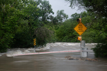 Flooded road with warning signs