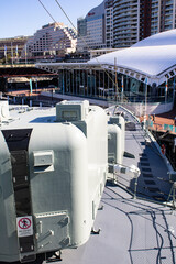 Capturing the majestic strength of an Australian naval warship in Sydney's sea, this strikingphoto features the formidable back of a cannon against the backdrop of Sydney's iconic cityscape. 