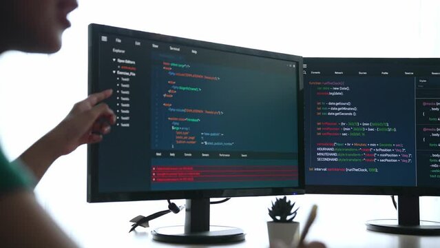 Slow motion back end software developer engineer for computer programming working together on debugging writing computing code, solving complex algorithms display on monitor in office. Burgeoning