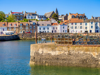St Monans, Fife, Scotland - the harbour and village, lobster pots stored on the jetty.