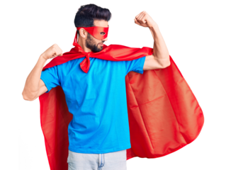 Young handsome man with beard wearing super hero costume showing arms muscles smiling proud. fitness concept.