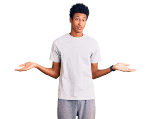 Young african american man wearing casual clothes clueless and confused expression with arms and hands raised. doubt concept.
