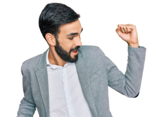 Young hispanic man wearing business clothes dancing happy and cheerful, smiling moving casual and confident listening to music