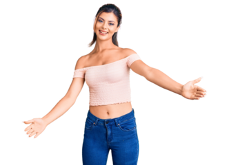 Young beautiful woman wearing casual clothes looking at the camera smiling with open arms for hug. cheerful expression embracing happiness.