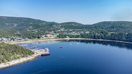 Naklejka premium Aerial view of Tadoussac bay and marina, taken by drone.