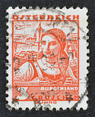 Cancelled postage stamp printed by Austria, that shows traditional costume -Burgenland, circa 1934.