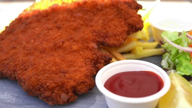 German Wiener schnitzel ( Schnitzel mit Pommes Frites ) at beer hall in Germany