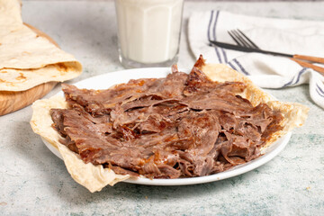 Meat Doner. Traditional Turkish cuisine taste. Cooked meat doner kebab on gray background. local name et doner. Close up