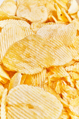 Close-up of crunchy salted potato chips filling the frame, conveying a sense of texture and flavor.
