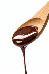 Obraz premium Liquid chocolate dripping from light wooden cooking spoon
