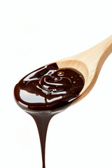 Obraz premium Liquid chocolate dripping from light wooden cooking spoon