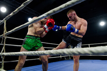 Kickboxing rivals unleash powerful leg strikes in a thrilling match.