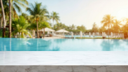Blurred swimming pool background behind empty marble tabletop at resort hotel, perfect for product display montage