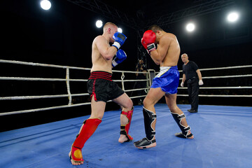 Fierce boxing match showcases athletes' power and skill.