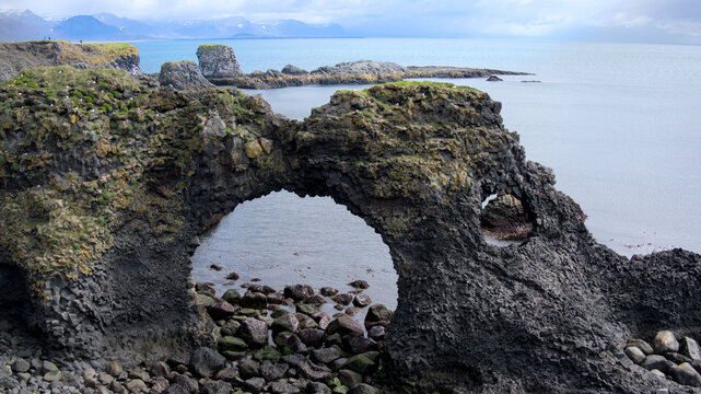 Panoramic view across the basalt cliffs with seagulls and rocks near Arnarstapi, Iceland