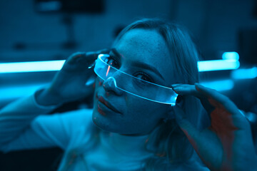 Portrait of a blonde in neon glasses.