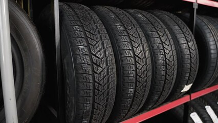 Car tires and wheels at warehouse in tire store. Different tires in an auto parts store