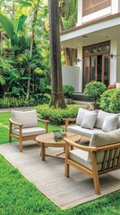 Obraz premium A curved stone pathway leads from the lawn to a stone patio in front of a house with a large glass back door