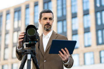 modern professional photographer. in a jacket photographs architecture.