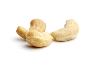 Close-up of three cashew nuts isolated on a white background. Ideal for health, nutrition, and culinary concepts