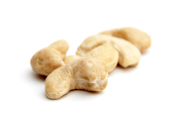 Close-up of several cashew nuts isolated on a white background. Ideal for illustrating healthy eating, snacks, and nutrition