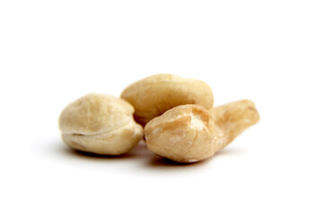 Close-up view of three cashew nuts isolated on a white background. Ideal for health, nutrition, and culinary use