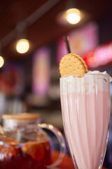 Delicious Strawberry Milkshake with Whipped Cream and Biscuit for a refreshing and satisfying treat