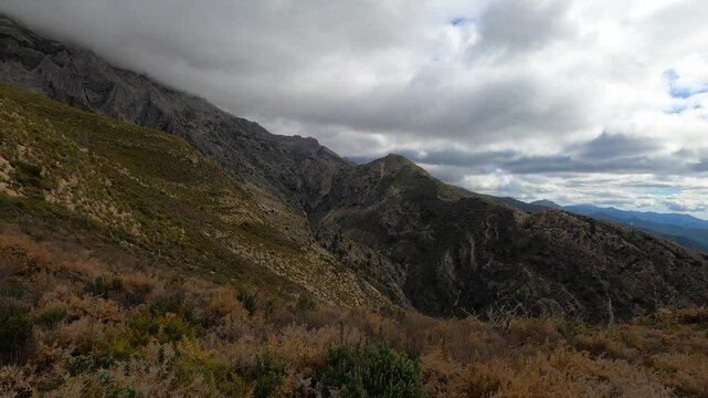 Fog and clouds on hiking trail to Maroma peak in thunderstorm day, Sierra Tejeda, Spain 