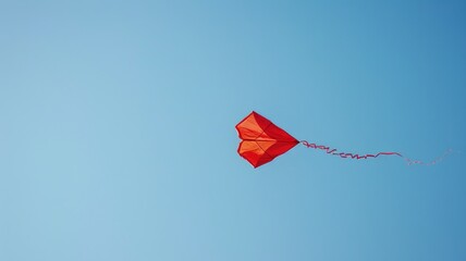 Red kite flying against clear blue sky