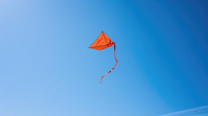 Red kite flying in clear blue sky