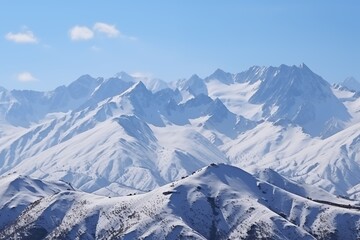 Fototapeta premium Majestic Snow-Covered Mountain Range Under a Blue Sky