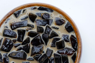 Fototapeta premium Grass jelly in milk with brown sugar, herbal dessert. Mesona chinensis