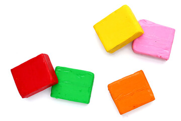 Colorful plasticine clay on white background.