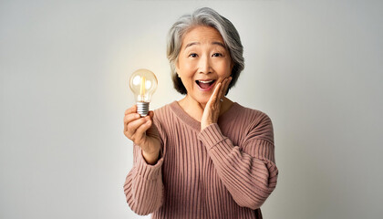 Senior Woman Holding a Light Bulb with an Idea