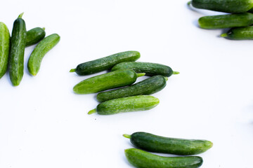 Mini cucumbers on white background.