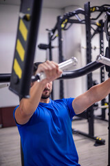 anonymous fitness athlete working chest muscles on gym machine