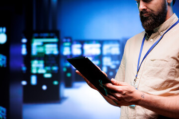 Specialist inspecting interlinked computers creating server network. Cloud computing service business using parallel computing to perform complex calculations and process large amounts of data