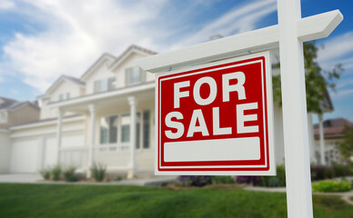 Fototapeta premium For Sale Real Estate Sign in Front of Beautiful House.